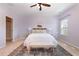 Bright bedroom features a ceiling fan, a comfortable bed with accent pillows, and soft natural light at 113 Callowhill Ln, Durham, NC 27713