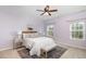 Light-filled bedroom with soft lilac walls, cozy rug, and comfortable furnishings at 113 Callowhill Ln, Durham, NC 27713