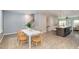 Open-concept dining area with white table, wood chairs, and an elegant rug near the kitchen island at 113 Callowhill Ln, Durham, NC 27713