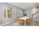 Well-lit dining room with large windows, a white table, and wood chairs creates an inviting atmosphere at 113 Callowhill Ln, Durham, NC 27713