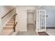 Entryway with wood stairs and trim, leading to other rooms with hardwood-style flooring at 113 Callowhill Ln, Durham, NC 27713