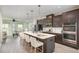 Modern kitchen with dark cabinets, quartz counters, an island with seating, and stainless appliances at 113 Callowhill Ln, Durham, NC 27713
