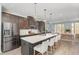 Modern kitchen boasts stainless steel appliances, an island with bar seating, and stylish pendant lighting at 113 Callowhill Ln, Durham, NC 27713