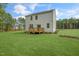 Spacious backyard view featuring a wooden deck and an expansive lawn at 135 Scenic Rock Dr, Youngsville, NC 27596