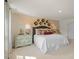 Relaxing bedroom with a decorative brick wall, neutral bedding, and stylish furniture at 135 Scenic Rock Dr, Youngsville, NC 27596
