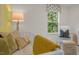 Well-lit Bedroom featuring a crib, cushioned chair, and soft, natural lighting at 135 Scenic Rock Dr, Youngsville, NC 27596