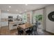 New kitchen island offers granite countertops and a breakfast bar open to the dining area and deck at 135 Scenic Rock Dr, Youngsville, NC 27596