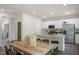 The island in this kitchen has a granite countertop with a stainless steel microwave, oven and fridge at 135 Scenic Rock Dr, Youngsville, NC 27596