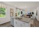 An island with granite countertops has a stainless steel dishwasher and sink looking into an open living space at 135 Scenic Rock Dr, Youngsville, NC 27596