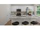 New kitchen features white cabinets, stainless appliances, granite countertops, and island with breakfast bar at 135 Scenic Rock Dr, Youngsville, NC 27596