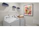 Bright laundry room featuring a Whirlpool washer and dryer and convenient shelving at 135 Scenic Rock Dr, Youngsville, NC 27596