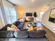 Cozy living room with large sectional sofa, bright natural light and a view of the stairs at 135 Scenic Rock Dr, Youngsville, NC 27596