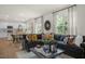 Living space offers a sectional sofa, dining table, kitchen and a view of a deck through the glass door at 135 Scenic Rock Dr, Youngsville, NC 27596