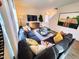 Comfortable living room with a large grey sectional, decorative pillows, television and wooden cabinet at 135 Scenic Rock Dr, Youngsville, NC 27596