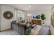Relaxing living room features large sectional sofa, television, hardwood floors and a circular wall decoration at 135 Scenic Rock Dr, Youngsville, NC 27596