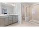 Bathroom featuring double vanity, tiled floors, and a glass-enclosed shower at 1430 Rosepine Dr, Cary, NC 27519