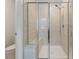 Modern bathroom with a glass-enclosed shower, complemented by tiled walls and a built-in bench at 1430 Rosepine Dr, Cary, NC 27519