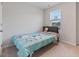Cozy bedroom showcasing a comfortable bed adorned with colorful bedding and a bright window at 1430 Rosepine Dr, Cary, NC 27519