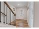 Entryway features hardwood floors, staircase with black iron spindles, and natural light creates a welcoming ambiance at 1430 Rosepine Dr, Cary, NC 27519