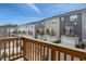 View of the townhome exteriors from the wooden deck, featuring multiple garages and parking spaces at 1430 Rosepine Dr, Cary, NC 27519