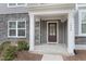 Inviting front porch with stone accents and a covered entry offers a welcoming entrance to the home at 1430 Rosepine Dr, Cary, NC 27519