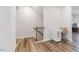 Hallway with wood floors and a staircase adjacent to a small white desk at 1430 Rosepine Dr, Cary, NC 27519