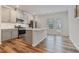Spacious kitchen with stainless steel appliances, gray cabinets, and a kitchen island at 1430 Rosepine Dr, Cary, NC 27519