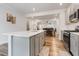 Open concept kitchen with a white island, stainless steel appliances, and hardwood floors at 1430 Rosepine Dr, Cary, NC 27519