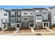 Modern townhomes with gray siding, stone accents, covered entries, and landscaped front yards offer curb appeal at 1430 Rosepine Dr, Cary, NC 27519