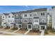 Modern townhomes with gray siding, stone accents, covered entries, and landscaped front yards offer curb appeal at 1430 Rosepine Dr, Cary, NC 27519