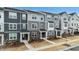 Modern townhomes with gray siding, stone accents, covered entries, and landscaped front yards offer curb appeal at 1430 Rosepine Dr, Cary, NC 27519