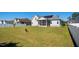 Spacious backyard with white fence, lawn, and home exterior featuring a screened porch at 156 Bornean Dr, Garner, NC 27529