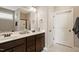 Bathroom featuring double sinks, dark wood cabinets, and a framed mirror at 156 Bornean Dr, Garner, NC 27529