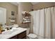 Bathroom featuring a vanity with open shelving and shower with white curtain at 156 Bornean Dr, Garner, NC 27529