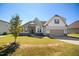 Charming home with a well-manicured lawn and a welcoming two-car garage at 156 Bornean Dr, Garner, NC 27529