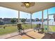 Relaxing screened porch featuring two chairs and a ceiling fan overlooking the backyard at 156 Bornean Dr, Garner, NC 27529