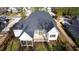 An aerial view of a home with a dark roof, white trim, a screened in porch, and a well manicured backyard at 162 Lookout Rdg # 677, Pittsboro, NC 27312