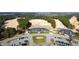 Aerial view of the golf course and clubhouse with manicured grounds and parking at 162 Lookout Rdg # 677, Pittsboro, NC 27312
