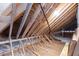 A partially finished attic featuring exposed rafters and insulation, perfect for storage at 162 Lookout Rdg # 677, Pittsboro, NC 27312