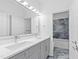 Bathroom featuring double sinks, gray cabinets, and marbled tile accents at 162 Lookout Rdg # 677, Pittsboro, NC 27312