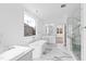 Modern bathroom with soaking tub, tiled floors, glass shower, and double vanity at 162 Lookout Rdg # 677, Pittsboro, NC 27312