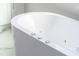 Close-up of a modern, white bathtub with sleek controls and a minimalist design at 162 Lookout Rdg # 677, Pittsboro, NC 27312