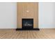 Modern fireplace with a wood panel surround and a black firebox in a well-lit room at 162 Lookout Rdg # 677, Pittsboro, NC 27312