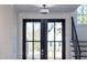 Front door with glass panels, allowing natural light to flood the foyer and staircase at 162 Lookout Rdg # 677, Pittsboro, NC 27312