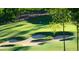 Scenic view of the golf course with sand traps, lush green fairways, and a distant flag at 162 Lookout Rdg # 677, Pittsboro, NC 27312