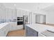 Spacious kitchen with gray island, quartz countertops, and stainless steel appliances at 162 Lookout Rdg # 677, Pittsboro, NC 27312
