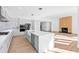 Modern kitchen featuring stainless steel appliances, a large island, and white cabinets at 162 Lookout Rdg # 677, Pittsboro, NC 27312