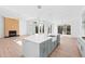 Bright, open kitchen with light grey cabinets, an island, and stainless steel appliances at 162 Lookout Rdg # 677, Pittsboro, NC 27312