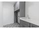 Laundry room with gray cabinets above and below the countertop and stylish tile flooring at 162 Lookout Rdg # 677, Pittsboro, NC 27312