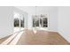 Bright living room with hardwood floors, sliding glass doors, and modern chandelier at 162 Lookout Rdg # 677, Pittsboro, NC 27312